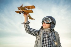Boy playing with toy airplane