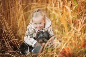 girl with down syndrome playing with her dog
